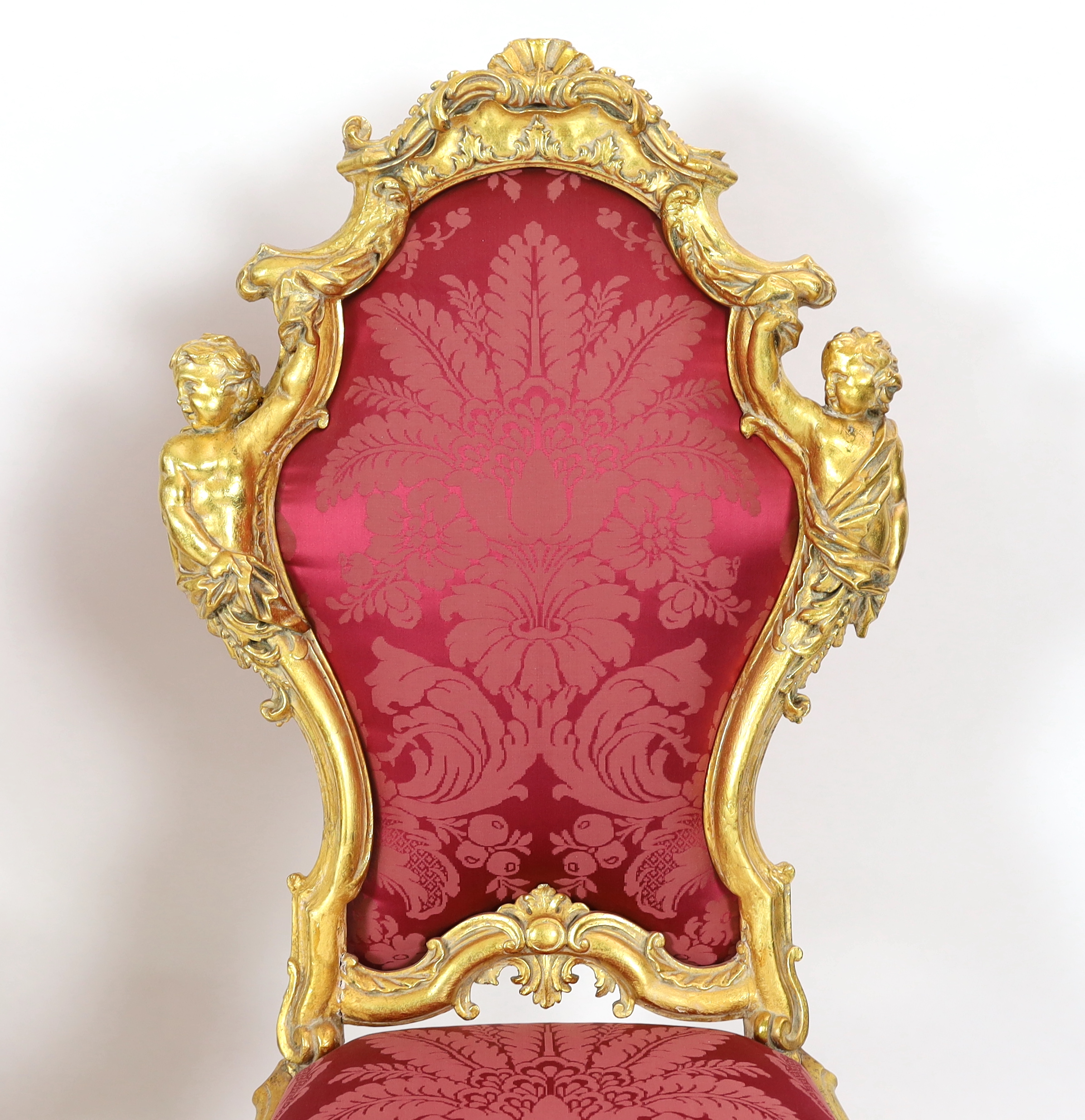 An important pair of late 18th century Venetian carved baroque giltwood throne chairs, the seats and backs upholstered in red floral silk. c.1770, 64cm wide, 55cm deep, 132cm high, Please note this lot attracts an additi